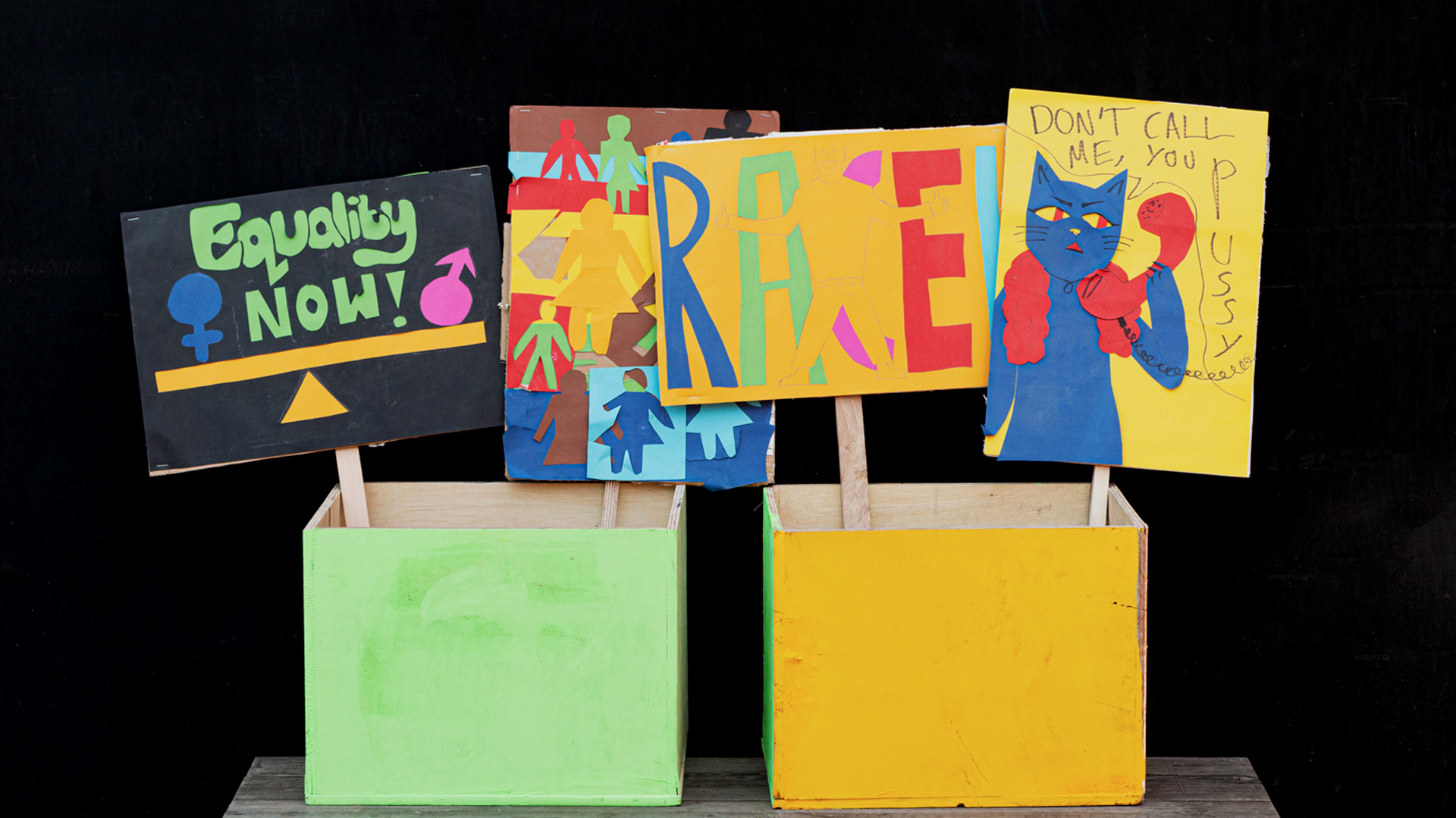 Protest placards against a black background