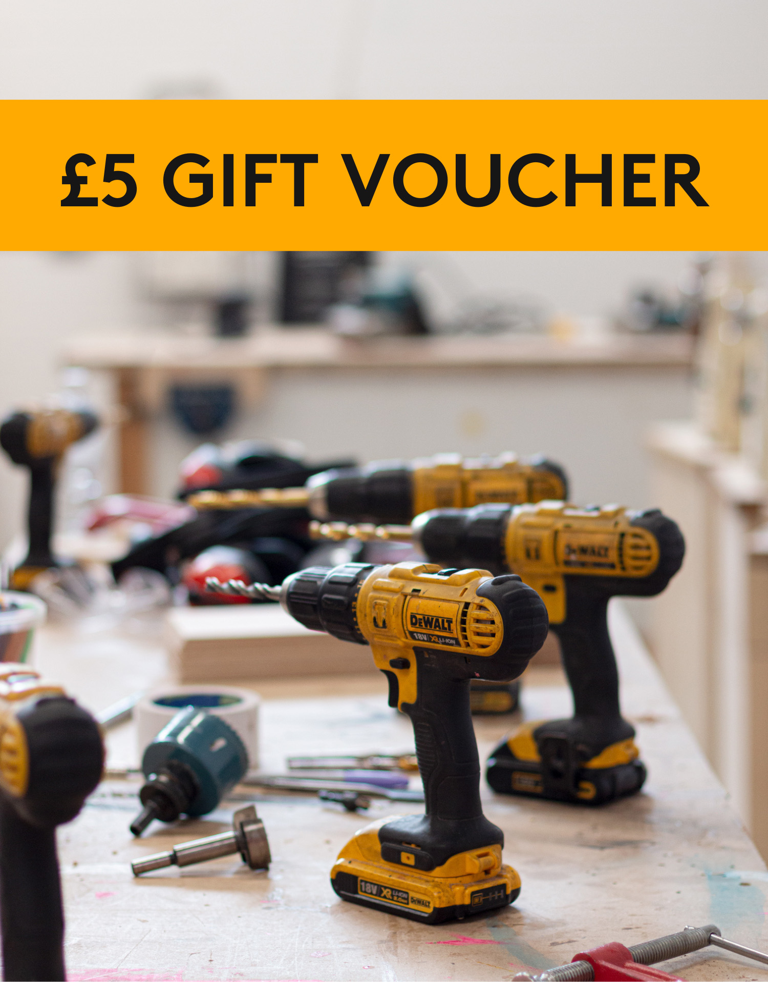 photograph of set of electric drills on a woodwork bench
