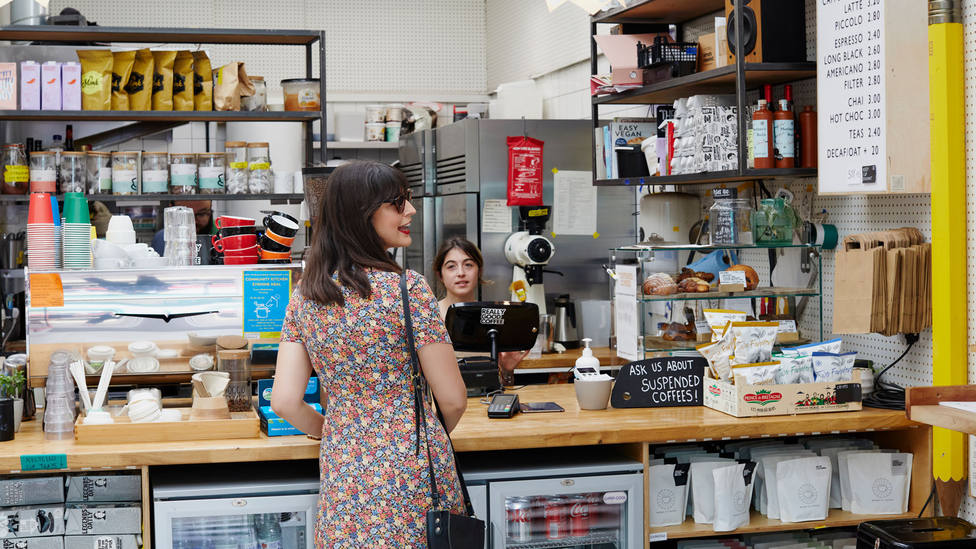 woman ordering at counter of cafe