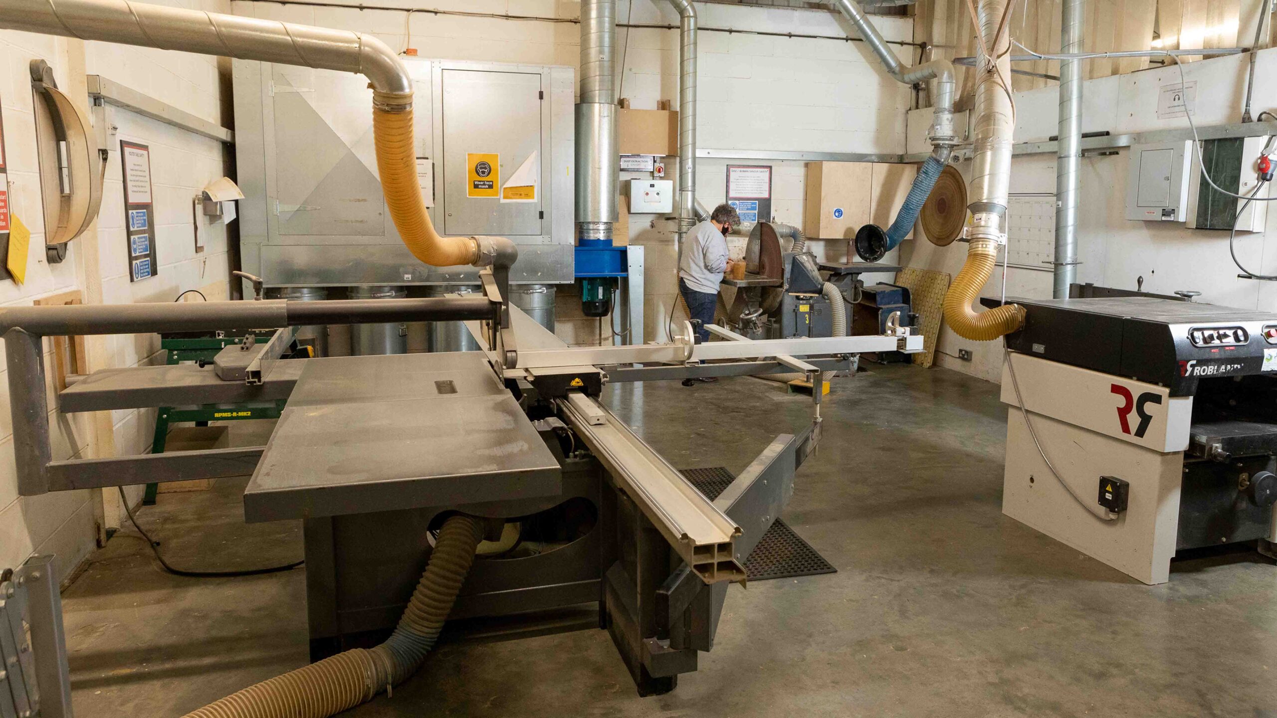 machine shop with table saw thicknesser and disc sander in background